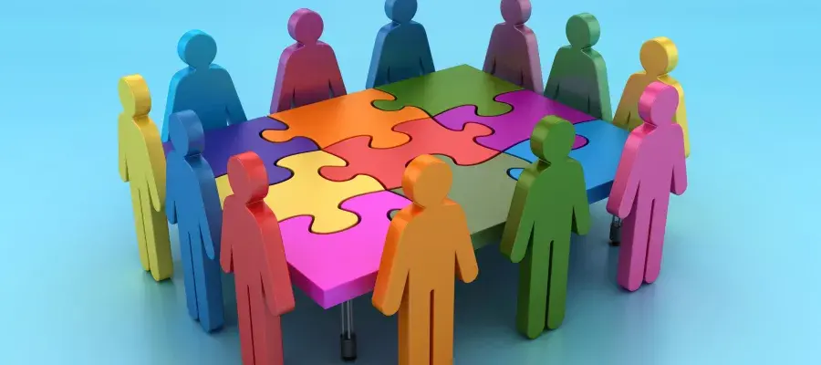 Pictogram people teamwork around a puzzle table